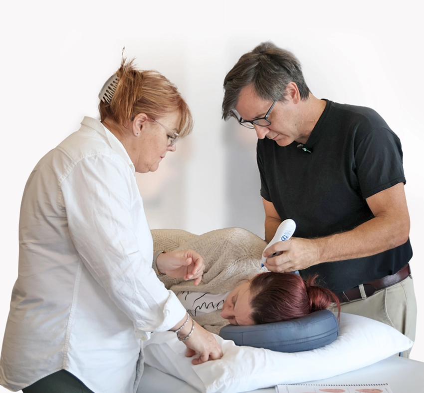 Practitioners using Dolphin Neurostim during a treatment session
